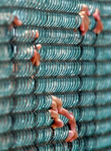 Duplicate: File photo of detainees holding onto a fence at maximum security prison Camp Delta at Guantanamo Naval Base