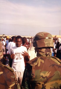 A Haitian refugee and US soldier meet at the holding camps at Guantánamo. Photo courtesy of Merrill Smith.