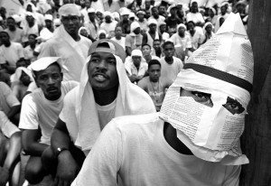 Haitian refugee disguised with mask at demonstration. Photo courtesy of Miami Herald.
